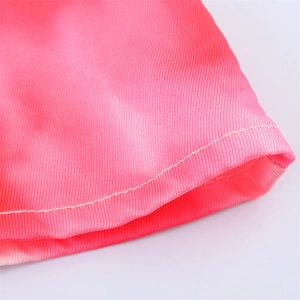 Detailed close-up of pink gradient satin fabric with neat single-needle stitching hem