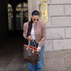 Classic monogram tote bag with red lining paired with a bomber jacket for casual street style