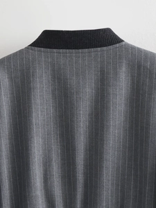 Detail of the black ribbed collar on a grey pinstripe jacket with fine texture