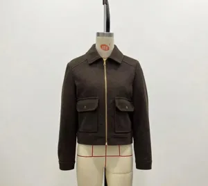 Detail of dark brown wool jacket featuring metal zipper and symmetrical cargo chest pockets