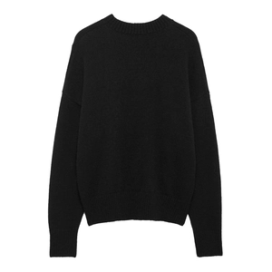 Detail of black crewneck knit sweater showing ribbed cuffs and soft fuzzy texture