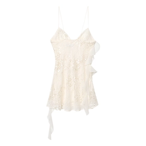 Detail view of white sequined mini dress with asymmetric layered chiffon ruffles