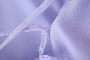 Detail shot of purple dress shoulder strap showing high-quality stitching and fabric texture