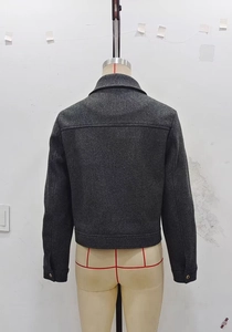 Detailed back view of a dark grey cropped jacket with high-quality wool texture and neat seams