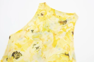 Detail of yellow floral print mesh fabric on a sleeveless round neck maxi dress