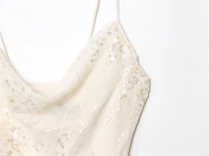 Detail of off-white sequin mesh dress featuring a cowl neck and fine adjustable straps