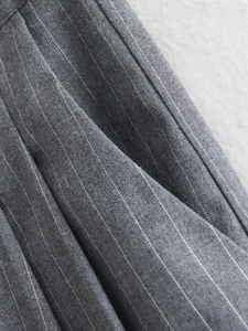 Macro shot of gray pinstripe fabric showing sewing details and material texture