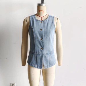 Detail of light blue denim vest showing vintage metal buttons and functional side pockets