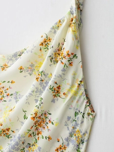 Detail of floral print silk-textured dress featuring delicate piping and lightweight fabric