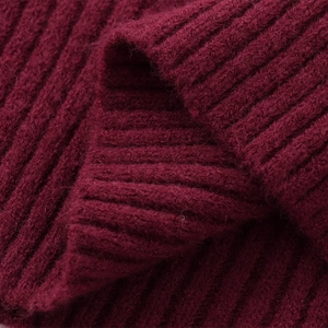 Detailed macro view showing the soft burgundy rib-knit texture and warm wool fabric