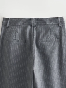 Detail view of pinstripe trousers back showing belt loops and rear welt pockets