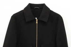 Detail of black wool-blend jacket with silver metal zipper and classic turnover collar