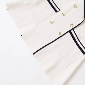 Elegant off-white sleeveless knitted top with gold buttons and navy blue trim detail