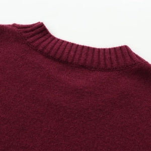 Detailed close-up of the burgundy crewneck sweater featuring premium ribbed knit texture
