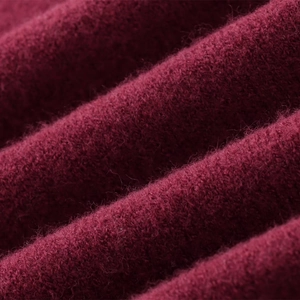 Close-up of deep wine red knitted sweater fabric with soft texture and detailed fibers