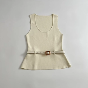 Beige sleeveless knit top with ribbed texture and belted waist detail on white background