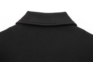 Close-up detail of the black wool fabric and collar craftsmanship on a women jacket