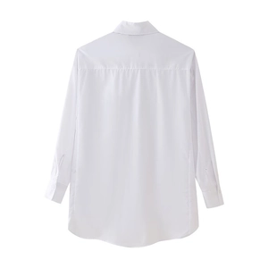 Detail view of white shirt back showing shoulder yoke and curved hemline in cotton blend