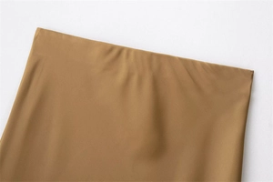 Macro detail of elastic waistband on khaki skirt showing smooth fabric and stitching
