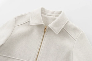 Detailed close-up of a soft wool-like oatmeal jacket featuring a premium metal zipper