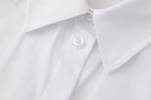 Detailed macro view of white shirt collar with sharp stitching and premium white buttons