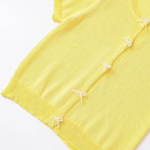 Short sleeve knit cardigan in yellow with elegant pearl bow decorations and round neck