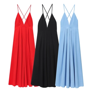 Detail view of backless V-neck maxi dresses showing cross straps and pleated waist details