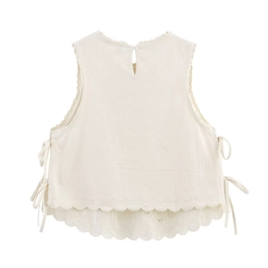 Women's sleeveless off-white top with back button, side bows and scallop hem
