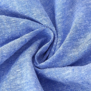 Close-up of high-quality light blue linen blend fabric with refined woven texture