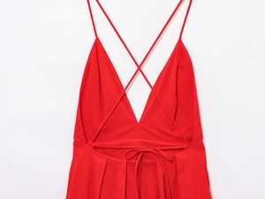 Detail of red backless maxi dress showing cross straps and invisible zipper closure