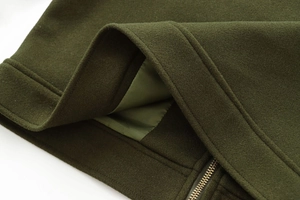 Detailed close-up of dark olive wool jacket with smooth satin lining and premium metal zipper