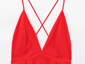 Detail of red deep V-neck dress with thin crisscross spaghetti straps on the chest