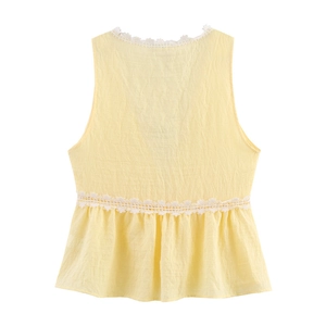 Pale yellow sleeveless top with white lace flower trim and ruffled hem design