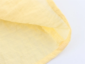 Macro detail of bright yellow sleeveless top featuring fine vertical rib texture and serging seam