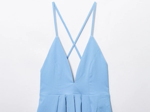 Close-up of light blue dress with deep V-neck and delicate cross-neck spaghetti straps