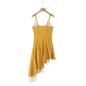 Detail of ginger yellow and white asymmetric hemline with layered ruffle edges on dress