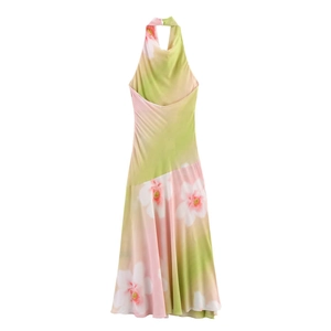 Detail of the elegant halter neck with floral print on a silky gradient dress