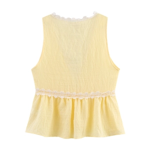 Pale yellow sleeveless top with white floral lace trim and ruffled peplum hem