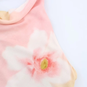 Detail of floral print fabric with pink and white flowers and yellow accents