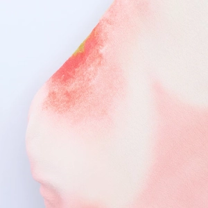 Detail shot of the pink gradient chiffon fabric with fine twill texture on a floral dress
