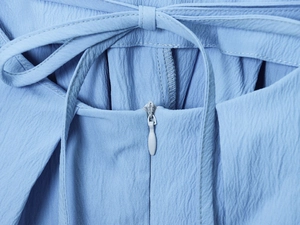 Detail of light blue dress showing invisible zipper and drawstring waist tie closure
