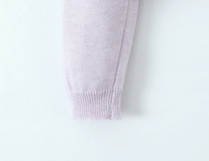 Close-up of lavender purple ribbed knit cuff with high-density stitching details