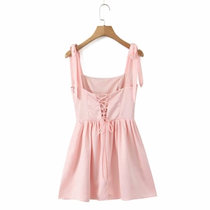 Detail of pink summer dress with ribbon shoulder straps and cross drawstring back tie