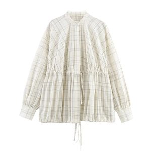 Detail of checkered blouse with adjustable drawstring waist and elegant lantern sleeves