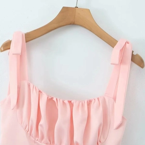 Elegant pink pleated camisole top with shoulder bow ties and light summer chiffon fabric
