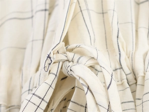 Close-up of drawstring waist detailing on a plaid cotton linen bomber jacket