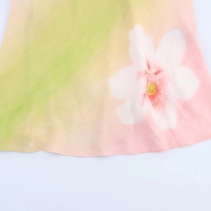 Floral print halter dress with vibrant gradient colors in light green and pink tones