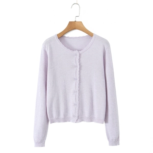 Light purple knitted cardigan with wavy scallop trim and round neck on wooden hanger