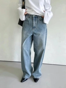 Detailed view of light blue wide-leg high-waisted denim jeans with classic vintage wash