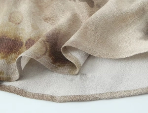 Detail of abstract tie-dye print chiffon fabric with refined rolled hem stitching